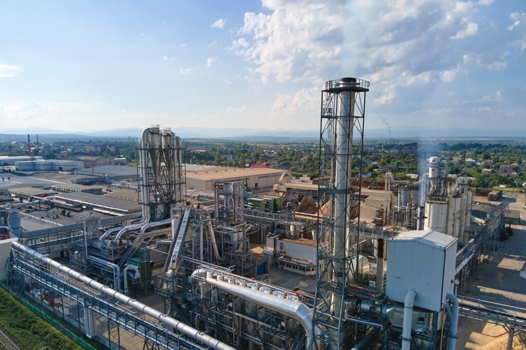 Aerial view of oil and gas refining petrochemical factory with tall refinery plant